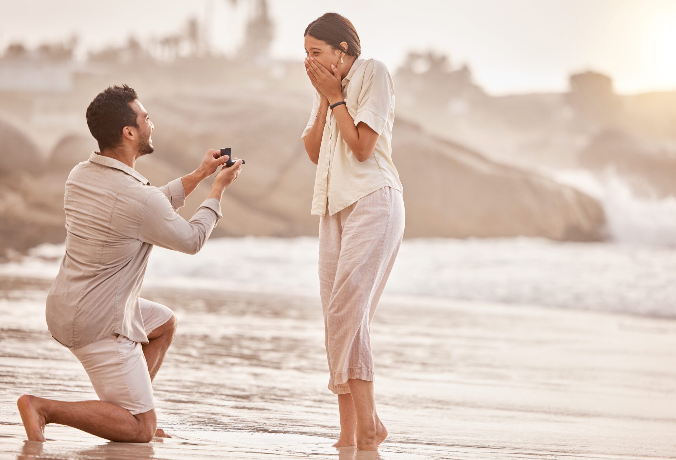 couple getting engard. Man proposing to woman at the beach. charleston, sc. Now they must ask questions before the wedding